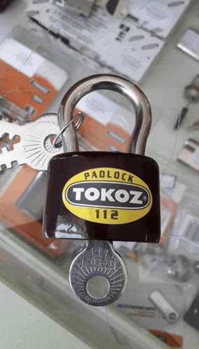 a padlock that says tokoz 112 is on a table