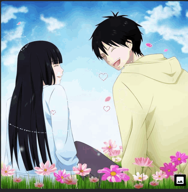 a boy and a girl sit in a field of pink flowers