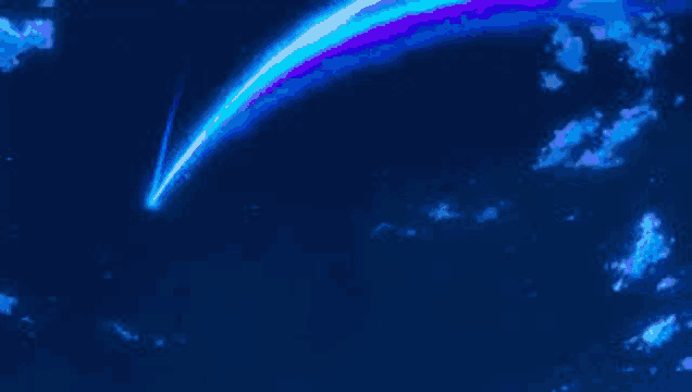 a shooting star with a rainbow coming out of it is flying through a blue sky .