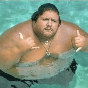 a very fat man is giving a thumbs up sign while swimming in a pool .