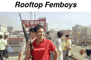 a man in a red shirt that says rooftop femboys on it