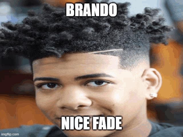 a young man with a nice fade hairstyle is smiling