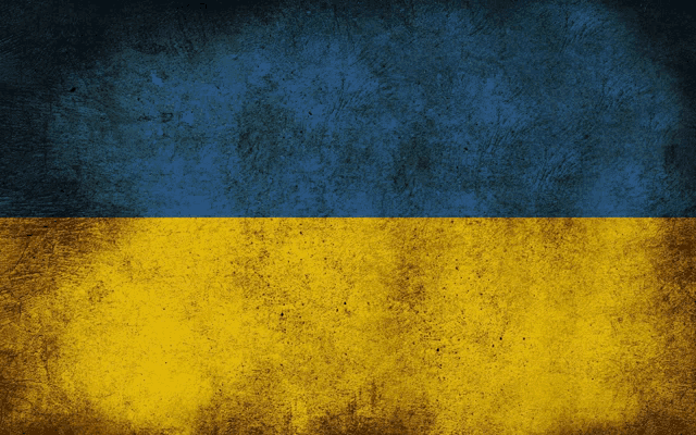 a blue and yellow flag with a grunge background