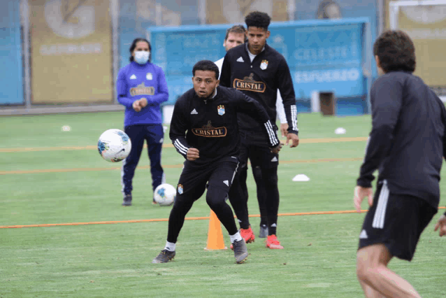 a group of soccer players with one wearing a shirt that says cristal on it