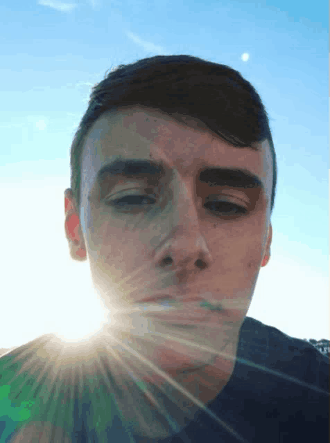 a close up of a man 's face with the sun shining on it