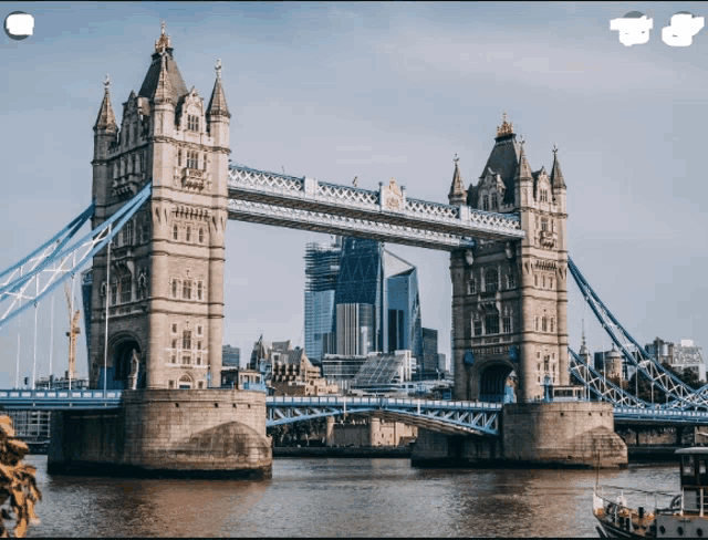 a bridge over a body of water with buildings in the background