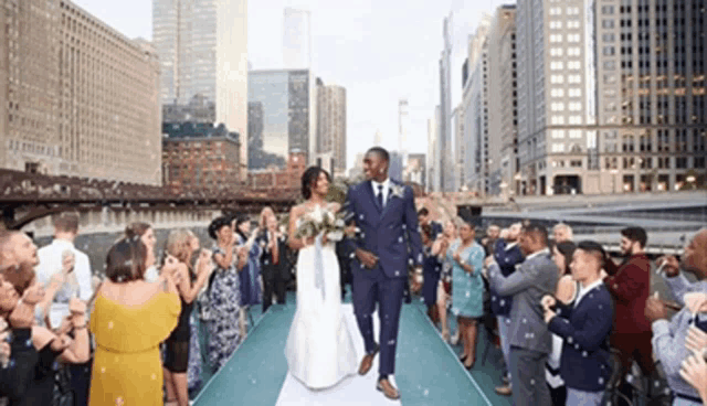 a bride and groom are walking down a aisle surrounded by bubbles