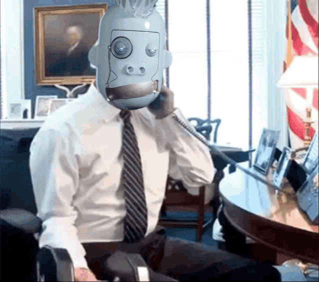 a man in a suit and tie has a robot head on his head