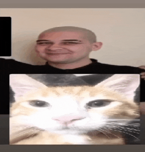 a man is holding a picture of a cat 's face in front of him