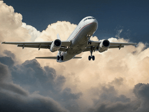 an airplane is flying through a cloudy sky with the landing gear down