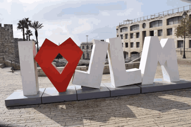 a large white sign that says i love lm with a red heart in the middle