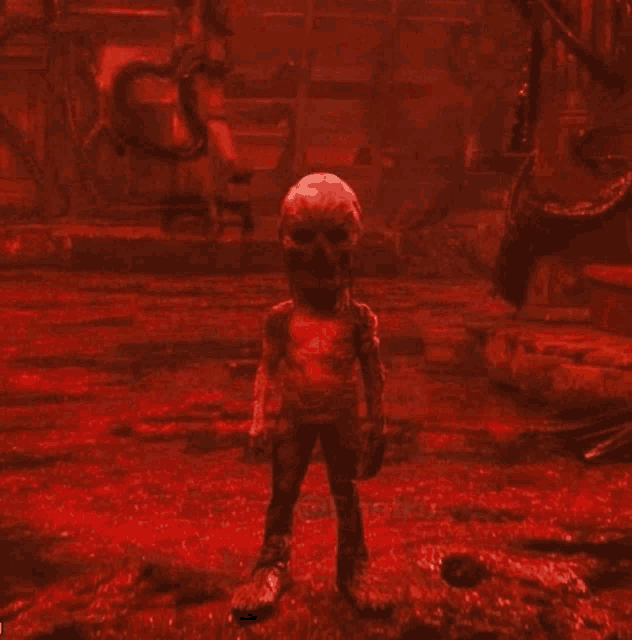 a red monster with a skull on its head is standing in a room