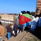 a group of people are standing in front of a flag