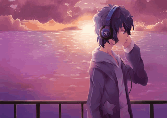 a boy wearing headphones with a star on them looks at the ocean