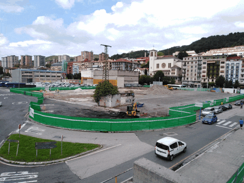 a white van is driving past a construction site