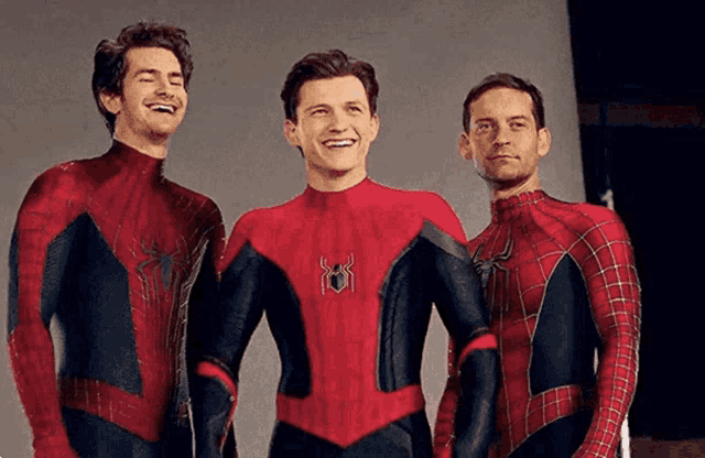 three men in spider-man costumes are posing for a picture