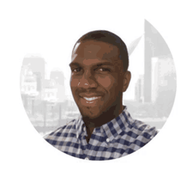 a man in a blue and white plaid shirt smiles in front of a city skyline