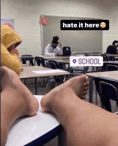 a classroom with a sign that says " hate it here " on it