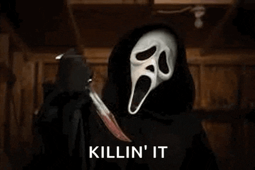 ghostface from the movie scream is holding a bloody knife in his hand .