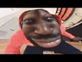 a close up of a man making a funny face while wearing a red hat .