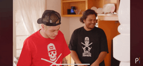 a man wearing a red t-shirt with a skull on it