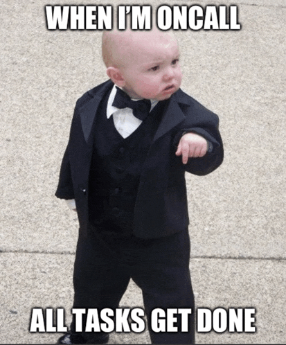 a baby wearing a tuxedo and bow tie points to the right