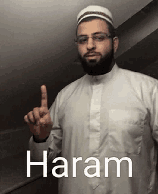 a man with a beard is wearing glasses and a white hat and has the word haram written on his shirt