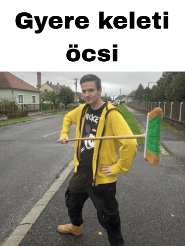 a man in a yellow jacket is holding a broom in front of a sign that says gyere keleti össi