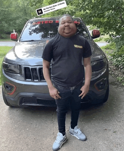 a man standing in front of a jeep with a sticker on it that says up the sun