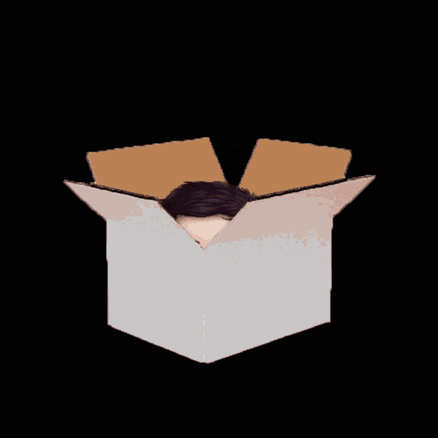 a boy 's head is sticking out of a cardboard box on a black background