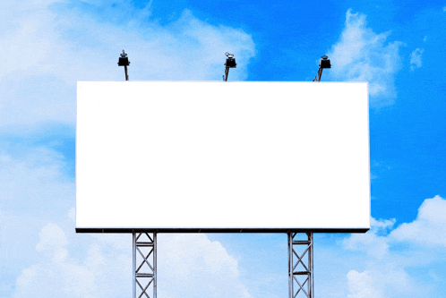 a billboard with a blue sky and clouds behind it