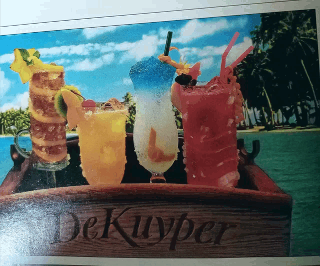 a wooden tray with a few drinks on it that says dekuyper