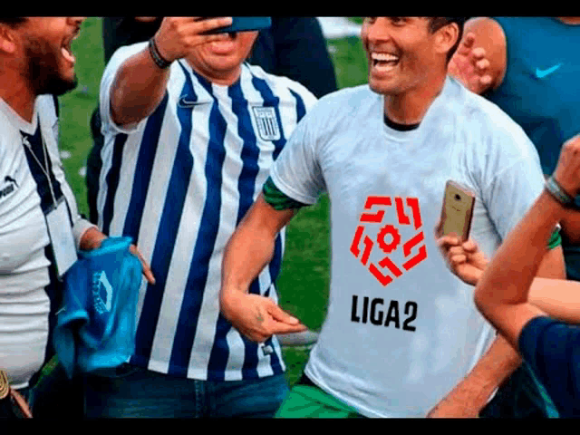 a man wearing a shirt that says liga2 is taking a picture of himself