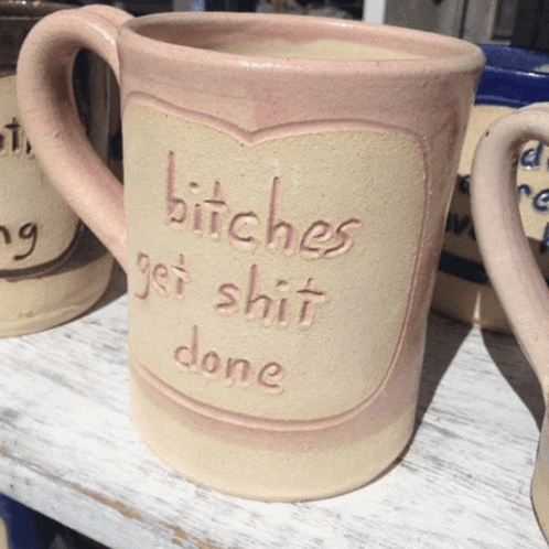 a pink mug that says bitches get shit done