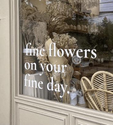 a window with flowers and the words fine flowers on your fine day