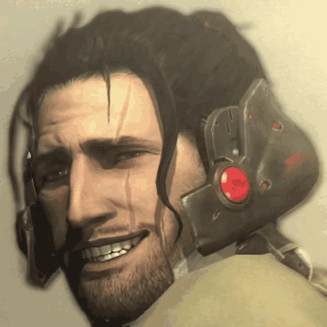 a close up of a man 's face with a red button on his ear