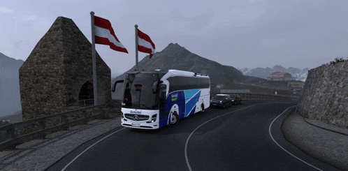 a mercedes bus is driving down a road with a mountain in the background