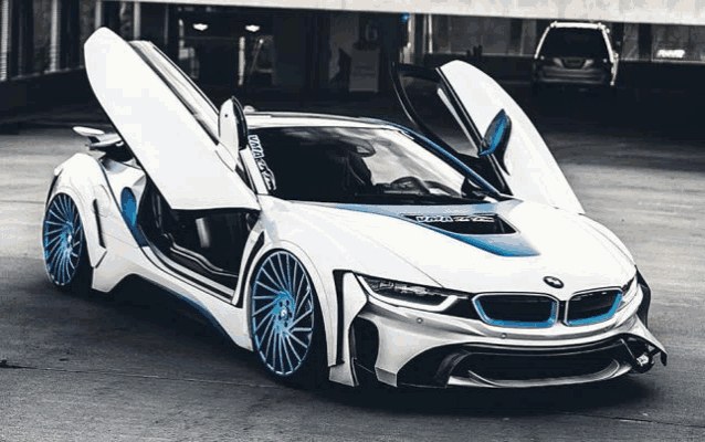 a white and blue bmw is parked in a parking garage