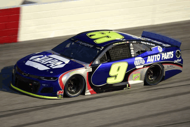 a napa auto parts race car is driving down a track