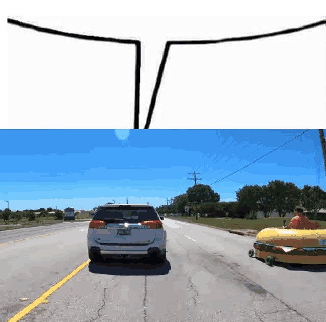 a white suv is driving down a road next to a yellow hamburger