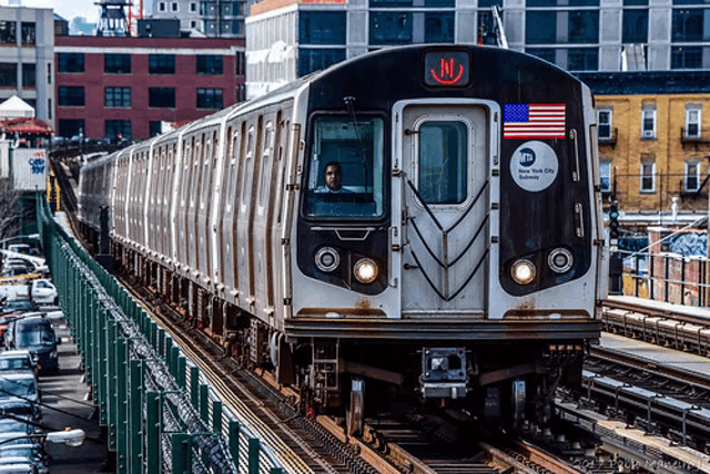 a new york city subway train is going down the track