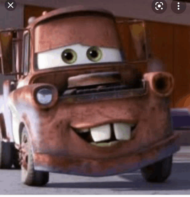 a rusty tow truck from cars with big teeth and big eyes .