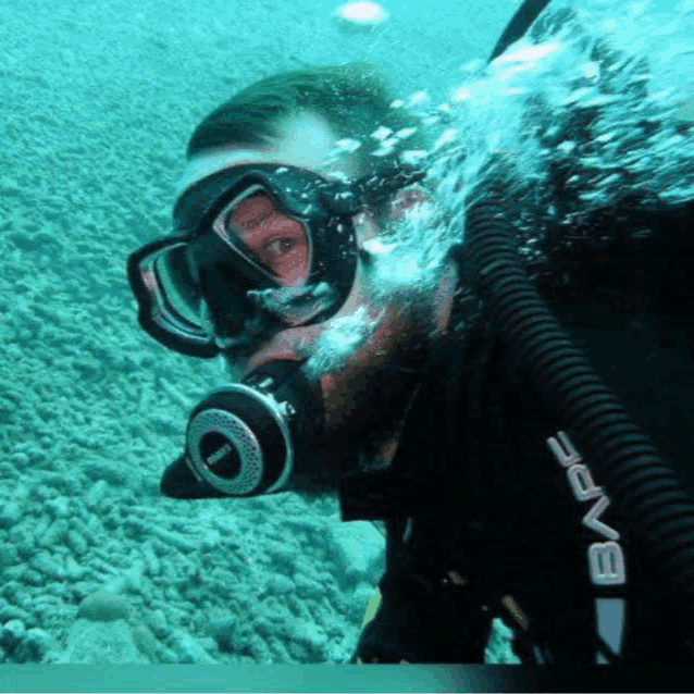 a man wearing a diving suit with the word wave on the front