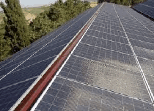 a row of solar panels sitting on top of a roof .