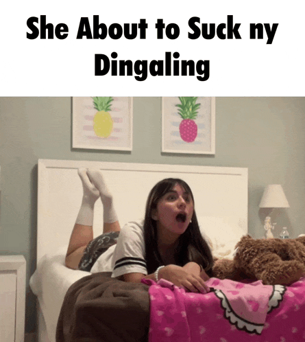 a girl is laying on her stomach on a bed with the words she about to suck ny dingaling above her