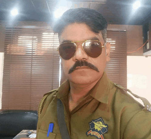 a man with a mustache wearing sunglasses and a badge that says ' passport '