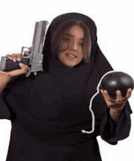 a woman in a nun costume is holding a gun and a bomb in her hands .