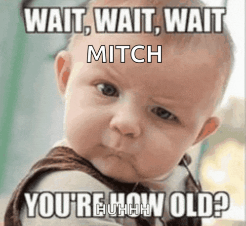 a baby making a funny face with a caption that says wait wait wait mitch you 're how old