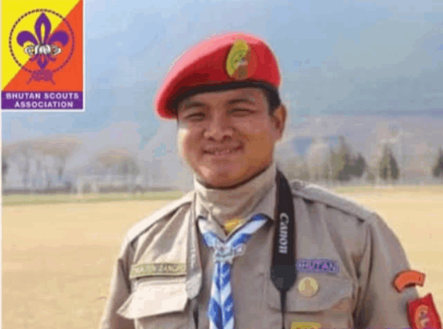 a man in a bhutan scouts association uniform smiles