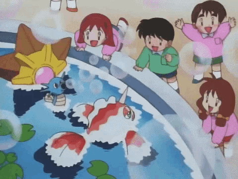 a group of children are standing around a pool of water with a fish in it .